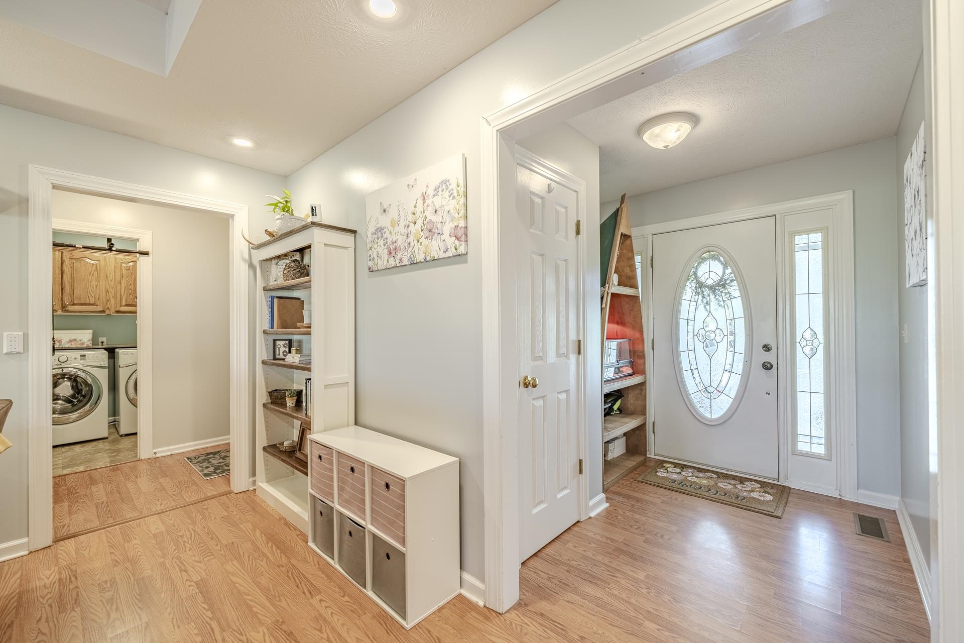 270 2 Boys Road Savannah, TN 38372 - Photo 9 of 35 Entrance foyer with light wood-type flooring, separate washer and dryer, and a barn door