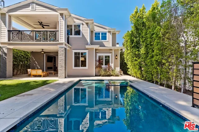 a swimming pool with outdoor seating and yard