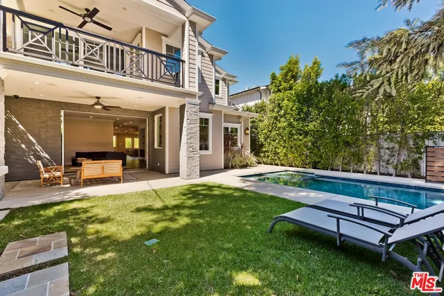a view of a hallway with wooden floor and windows