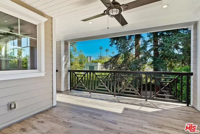 a bedroom with a bed and a flat tv screen on dresser