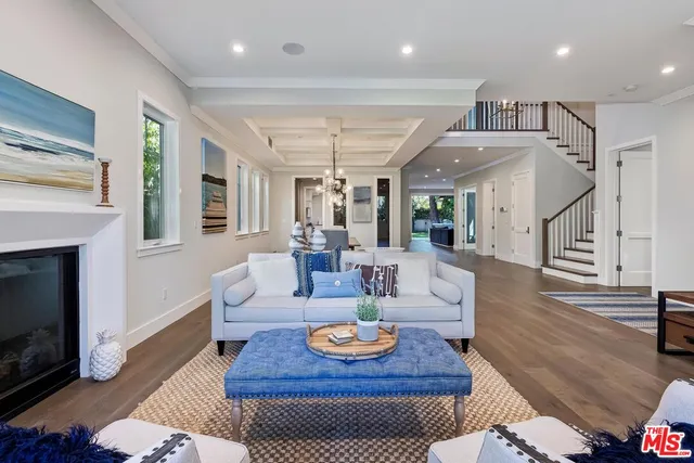 a living room with furniture fireplace and a table