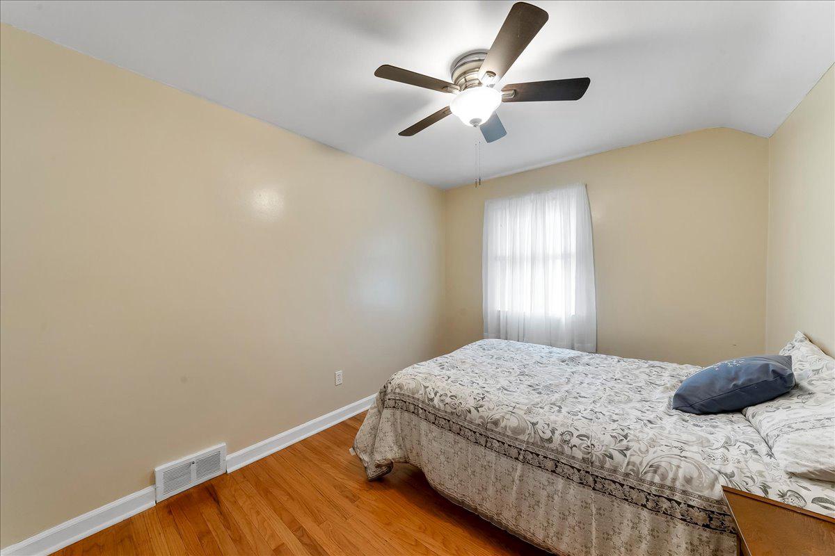 345 Holt Lane Springfield, PA 19064 - Photo 17 of 38 First bedroom with hardwood floors and ceiling fan