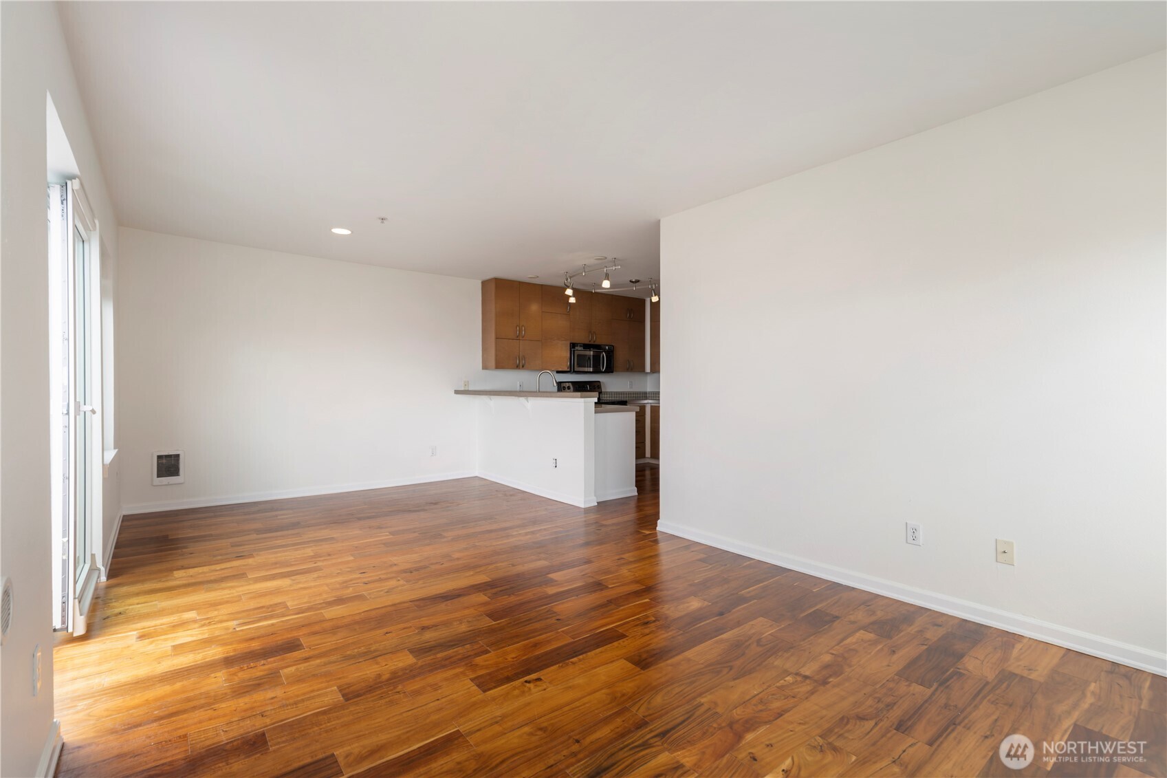 2440 Western Avenue, Unit 807 Seattle, WA 98121 - Photo 11 of 32 a view of a kitchen with wooden floor and electronic appliances