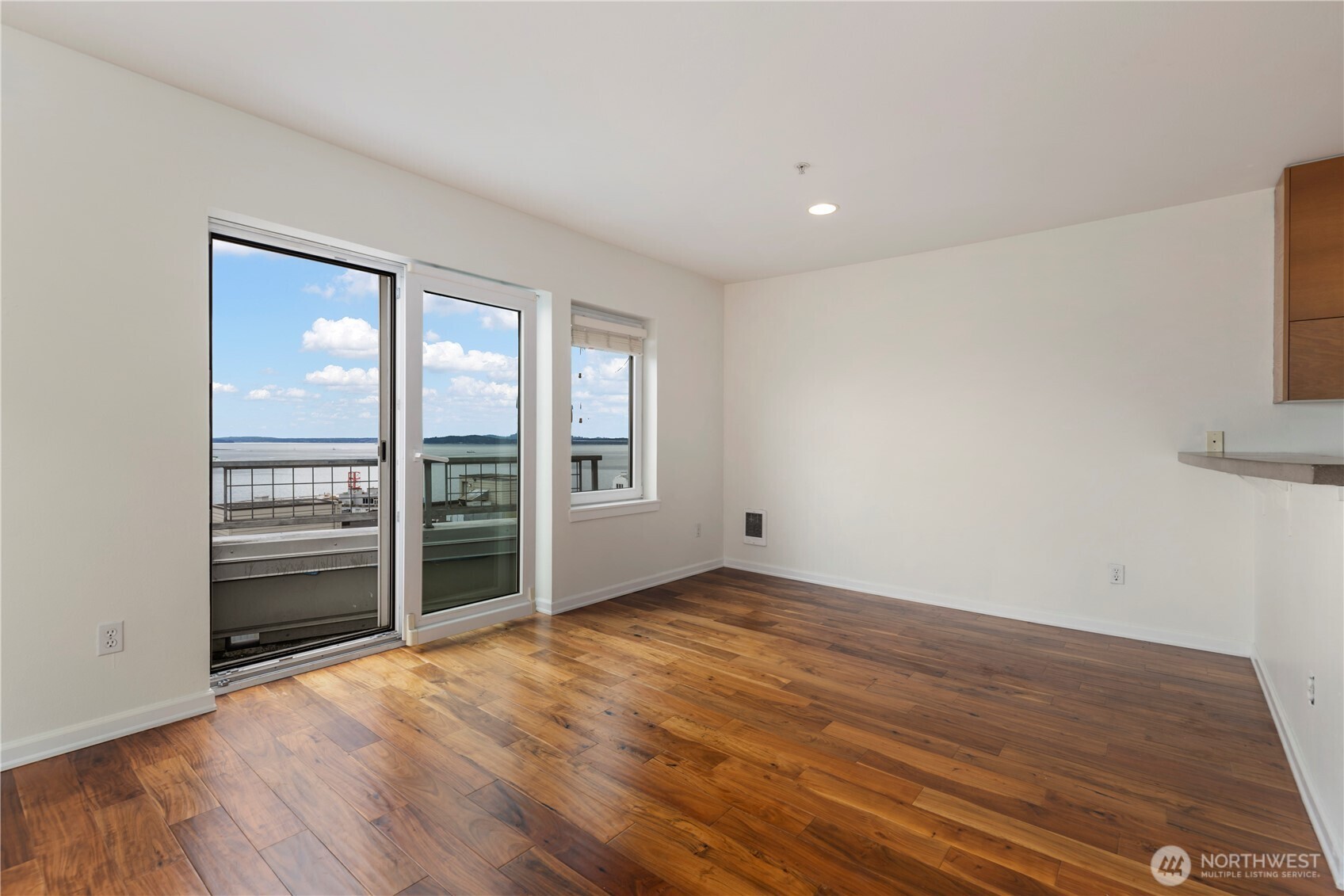 2440 Western Avenue, Unit 807 Seattle, WA 98121 - Photo 12 of 32 a view of an empty room with a window and wooden floor