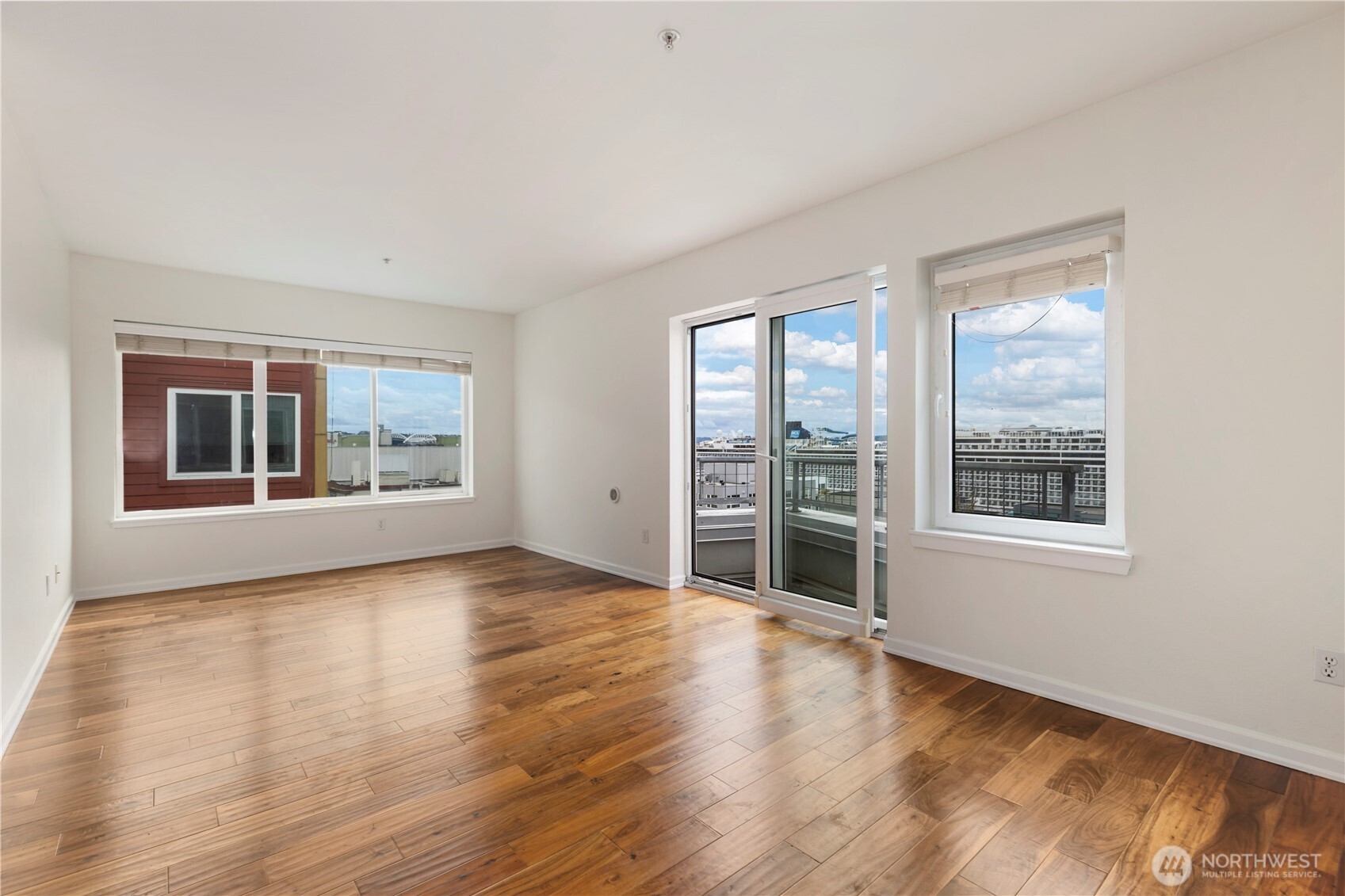 2440 Western Avenue, Unit 807 Seattle, WA 98121 - Photo 15 of 32 a view of an empty room with a window and wooden floor