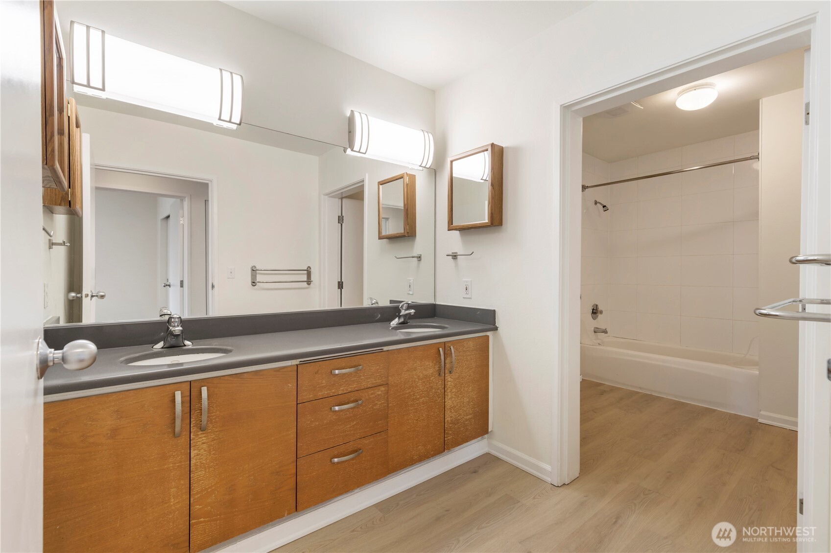 2440 Western Avenue, Unit 807 Seattle, WA 98121 - Photo 23 of 32 a bathroom with a granite countertop sink and a mirror
