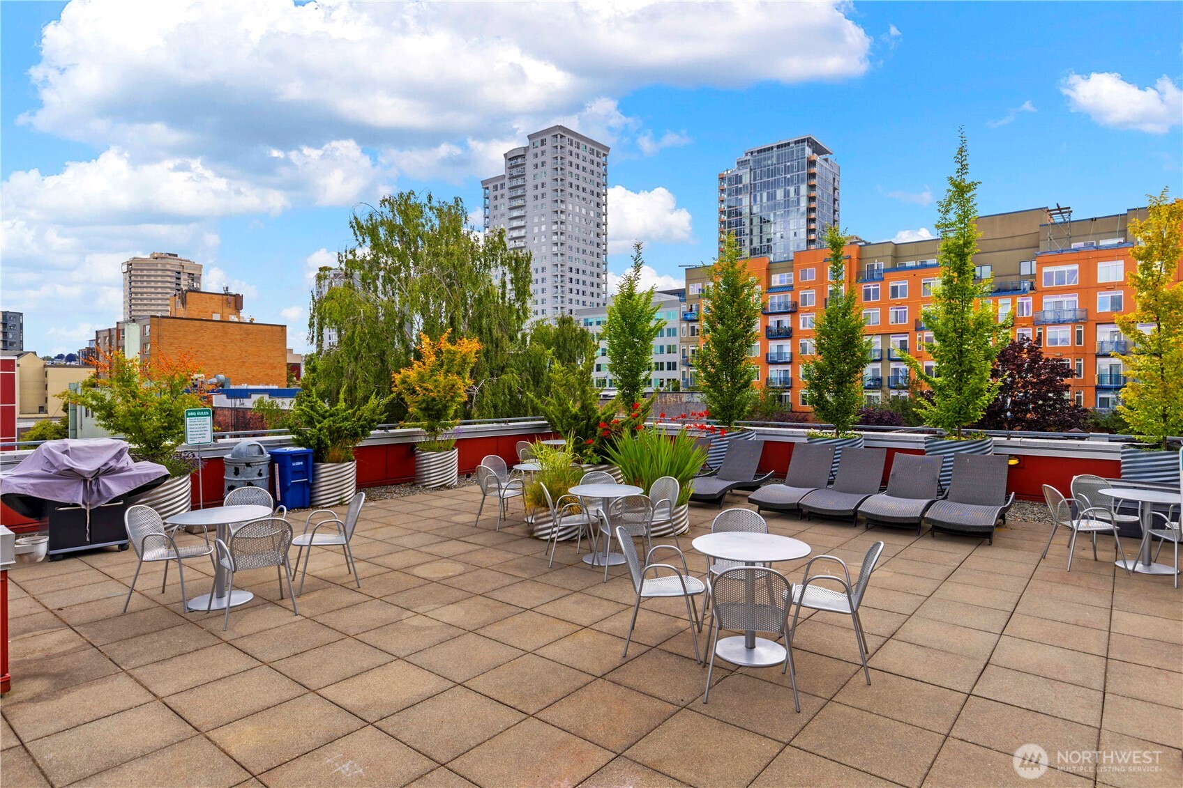 2440 Western Avenue, Unit 807 Seattle, WA 98121 - Photo 26 of 32 a group of chairs sitting in roof of a building and city view