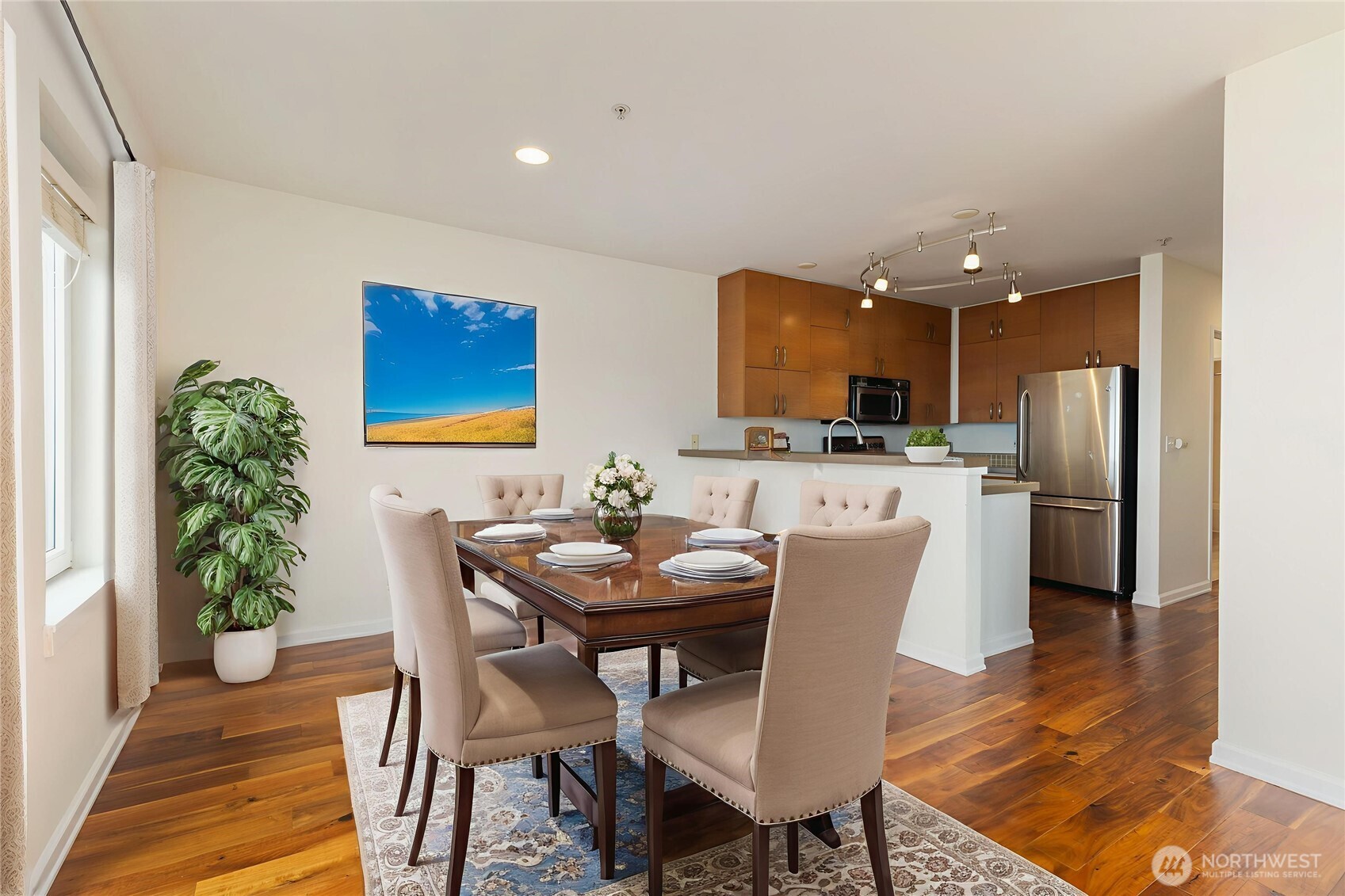 2440 Western Avenue, Unit 807 Seattle, WA 98121 - Photo 10 of 32 a view of a dining room with furniture and wooden floor