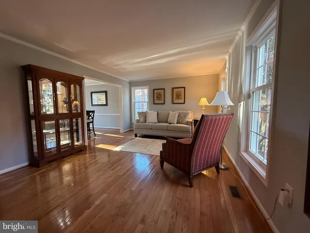 a large kitchen with stainless steel appliances granite countertop a large center island and a wooden floors