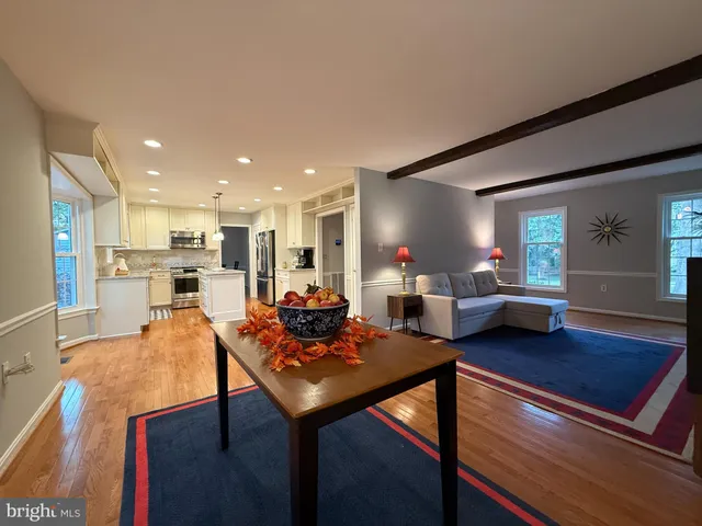 a view of a workspace with wooden floor and a window