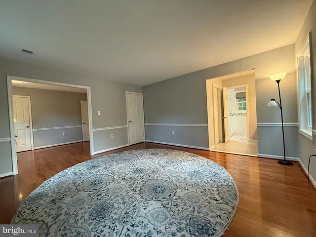 a view of a room with wooden floor