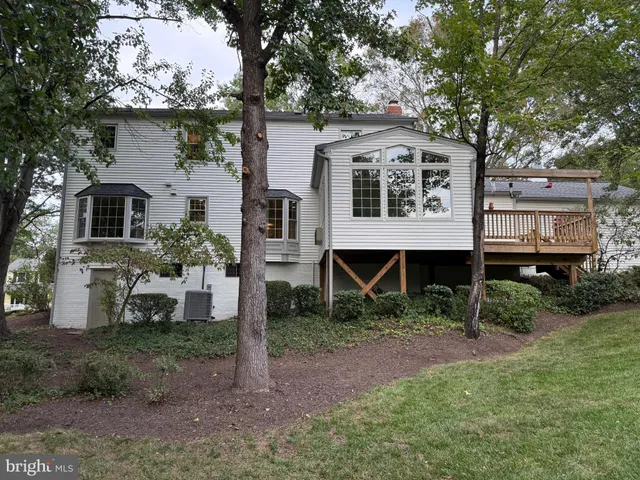a view of a house with backyard and wooden fence