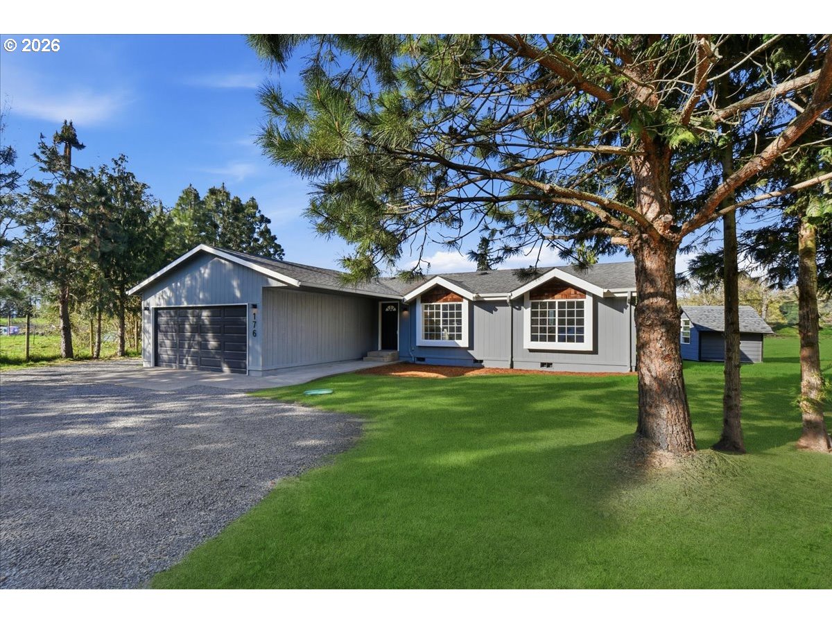 176 Tara Lane Vader, WA 98593 - Photo 35 of 36 a front view of a house with a yard and garage