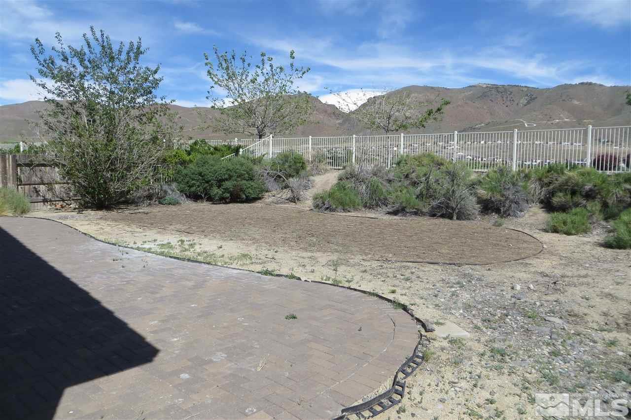 10092 Cascade Falls Drive Reno, NV 89521 - Photo 17 of 22 a view of a dry yard with mountains in the background