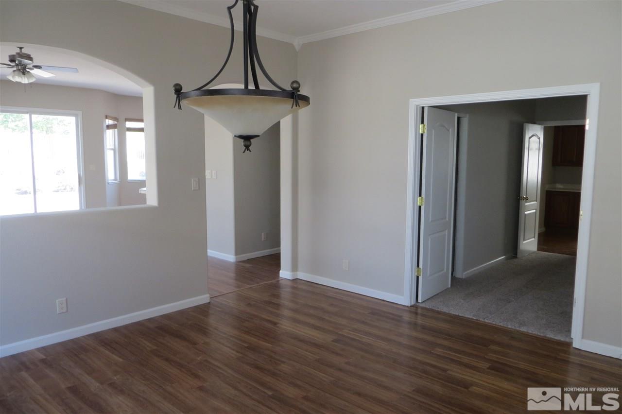 10092 Cascade Falls Drive Reno, NV 89521 - Photo 3 of 22 an empty room with wooden floor and windows