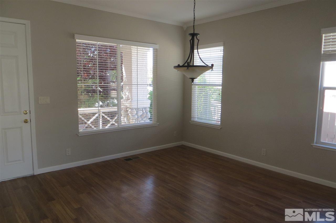10092 Cascade Falls Drive Reno, NV 89521 - Photo 4 of 22 a view of an empty room with wooden floor and a window