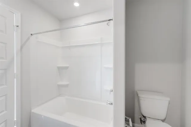 a bathroom with a bathtub and a toilet