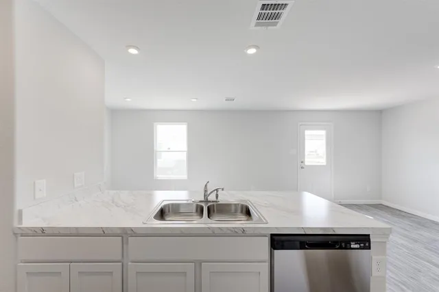 a kitchen with a sink and cabinets