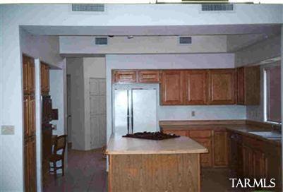 1 East Desert Sky Road, Unit 15 Tucson, AZ 85737 - Photo 6 of 6 a kitchen with stainless steel appliances granite countertop a sink a stove and a wooden floors