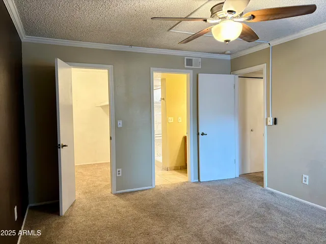 a view of a livingroom with a chandelier fan and hallway