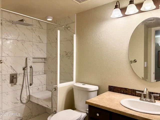 a bathroom with a sink toilet and shower