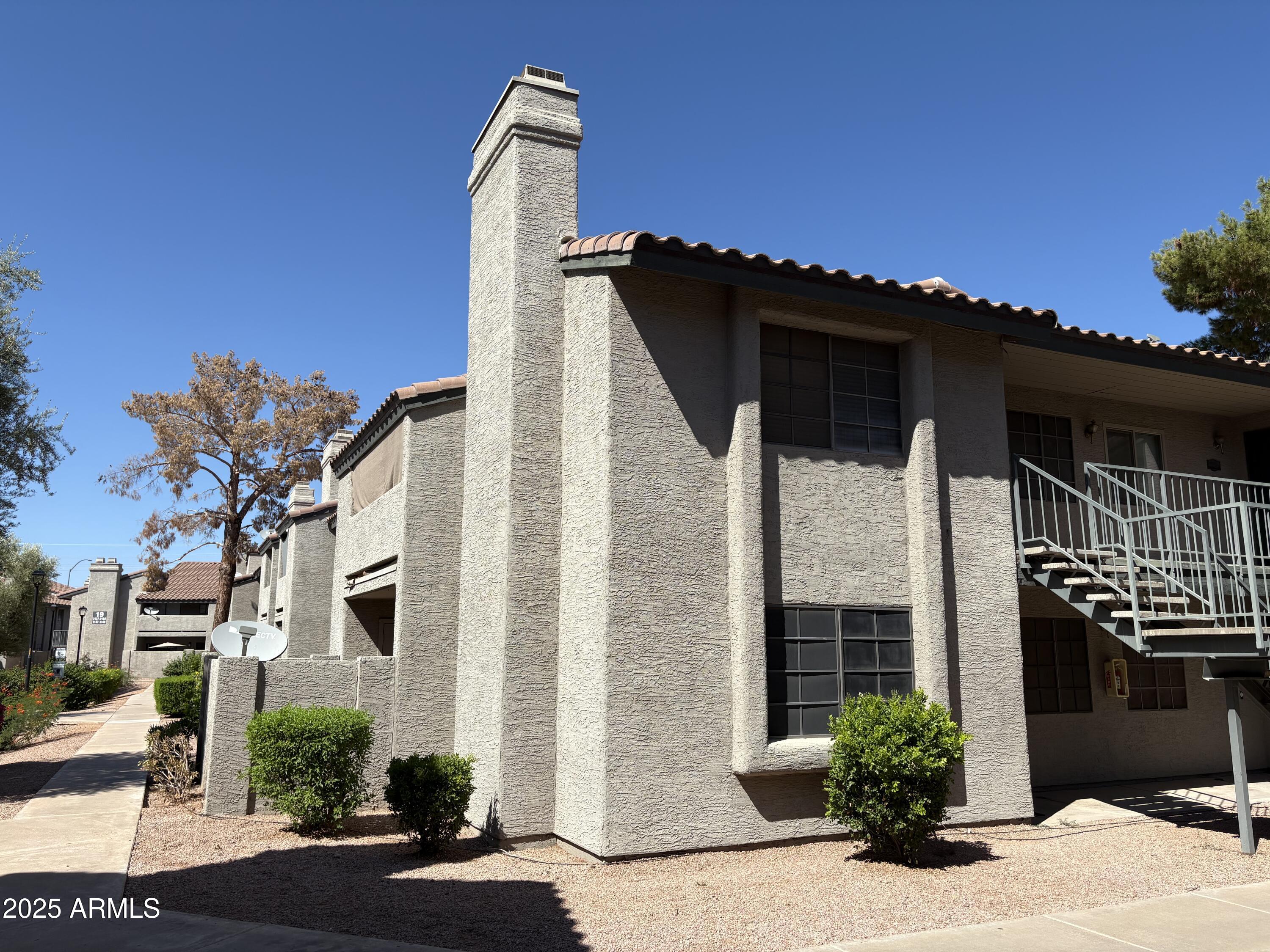 533 West Guadalupe Road, Unit 1122 Mesa, AZ 85210 - Photo 24 of 24 a front view of a house with a yard