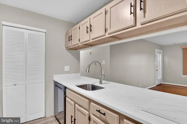 a kitchen with stainless steel appliances granite countertop a sink and a white cabinets