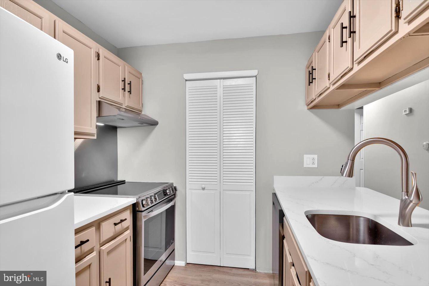 1966 The Woods II Cherry Hill, NJ 08003 - Photo 14 of 33 a kitchen with stainless steel appliances a sink a stove and a refrigerator