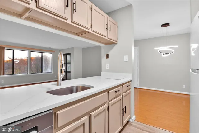 a kitchen with a sink and large window
