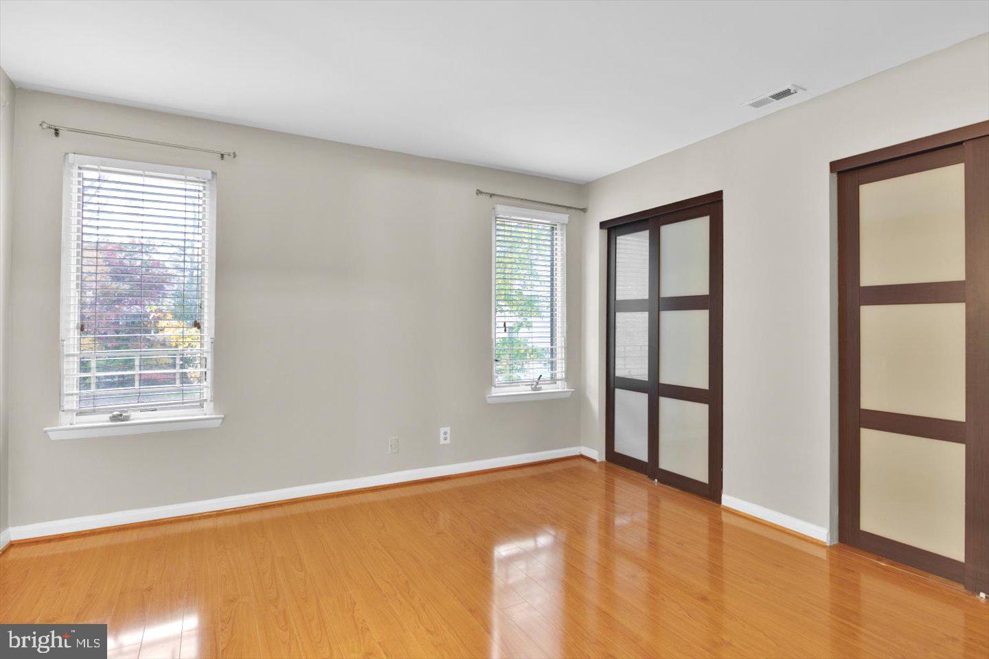 1966 The Woods II Cherry Hill, NJ 08003 - Photo 21 of 33 a view of empty room with windows and wooden floor