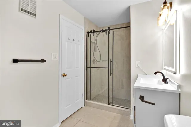 a bathroom with a shower sink and mirror