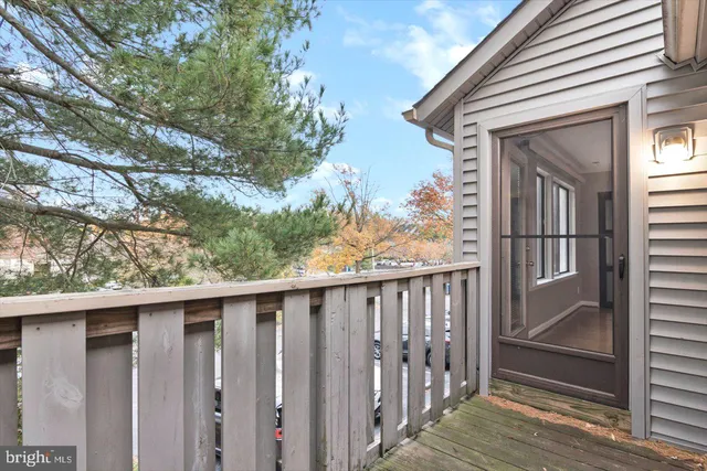 a porch with wooden floor in front of it