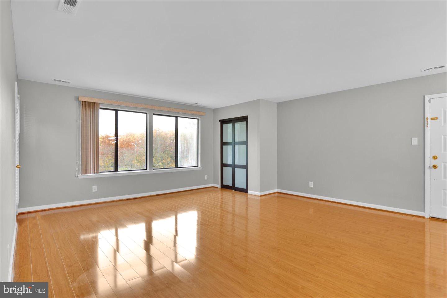 1966 The Woods II Cherry Hill, NJ 08003 - Photo 8 of 33 a view of an empty room with wooden floor and a window