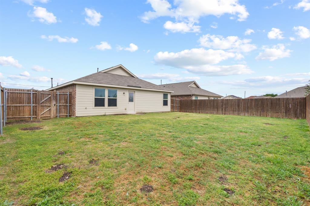 2604 Spring Time Drive Ennis, TX 75119 - Photo 21 of 21 a view of a house with a backyard