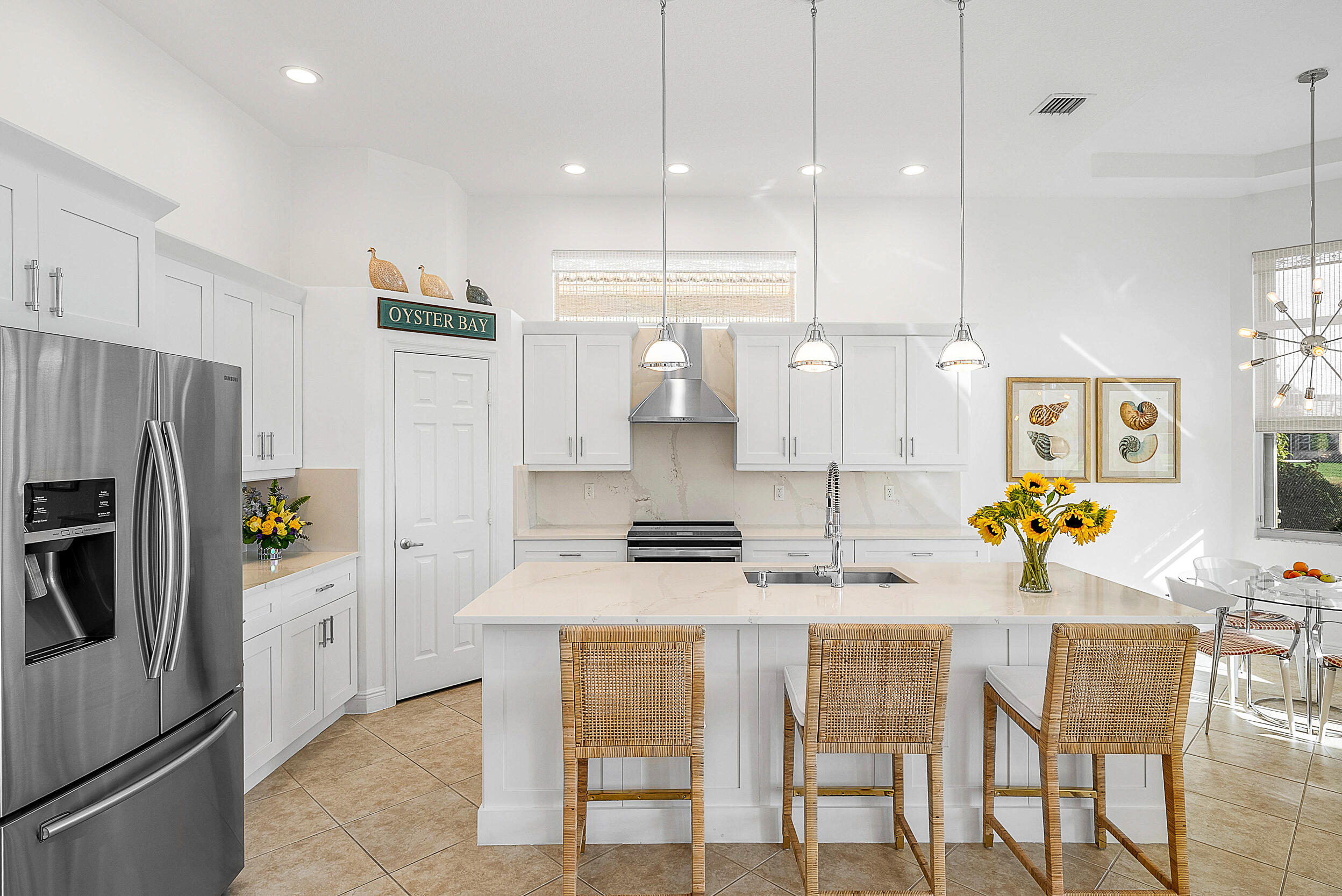 9666 Via Elegante Wellington, FL 33411 - Photo 12 of 37 a kitchen with a refrigerator and chairs