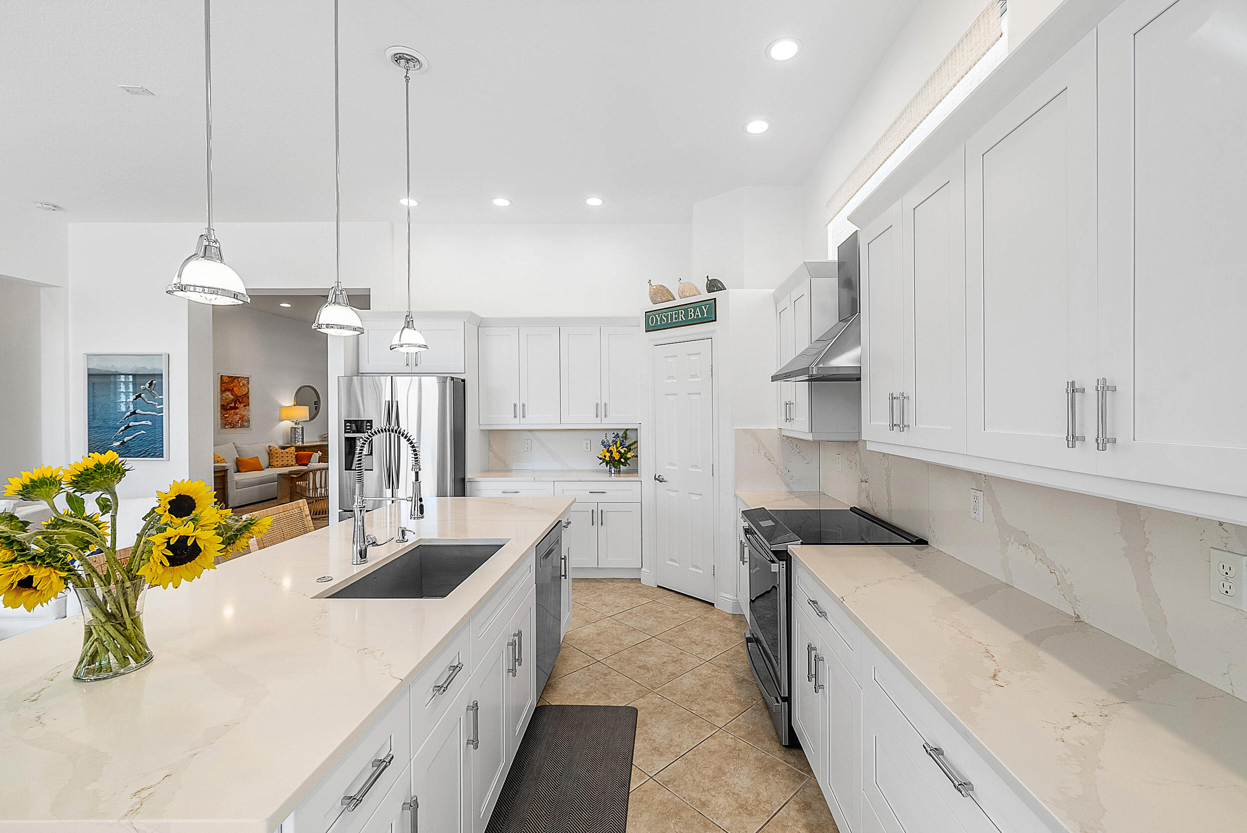 9666 Via Elegante Wellington, FL 33411 - Photo 13 of 37 a kitchen with kitchen island granite countertop a sink a counter top space appliances and cabinets