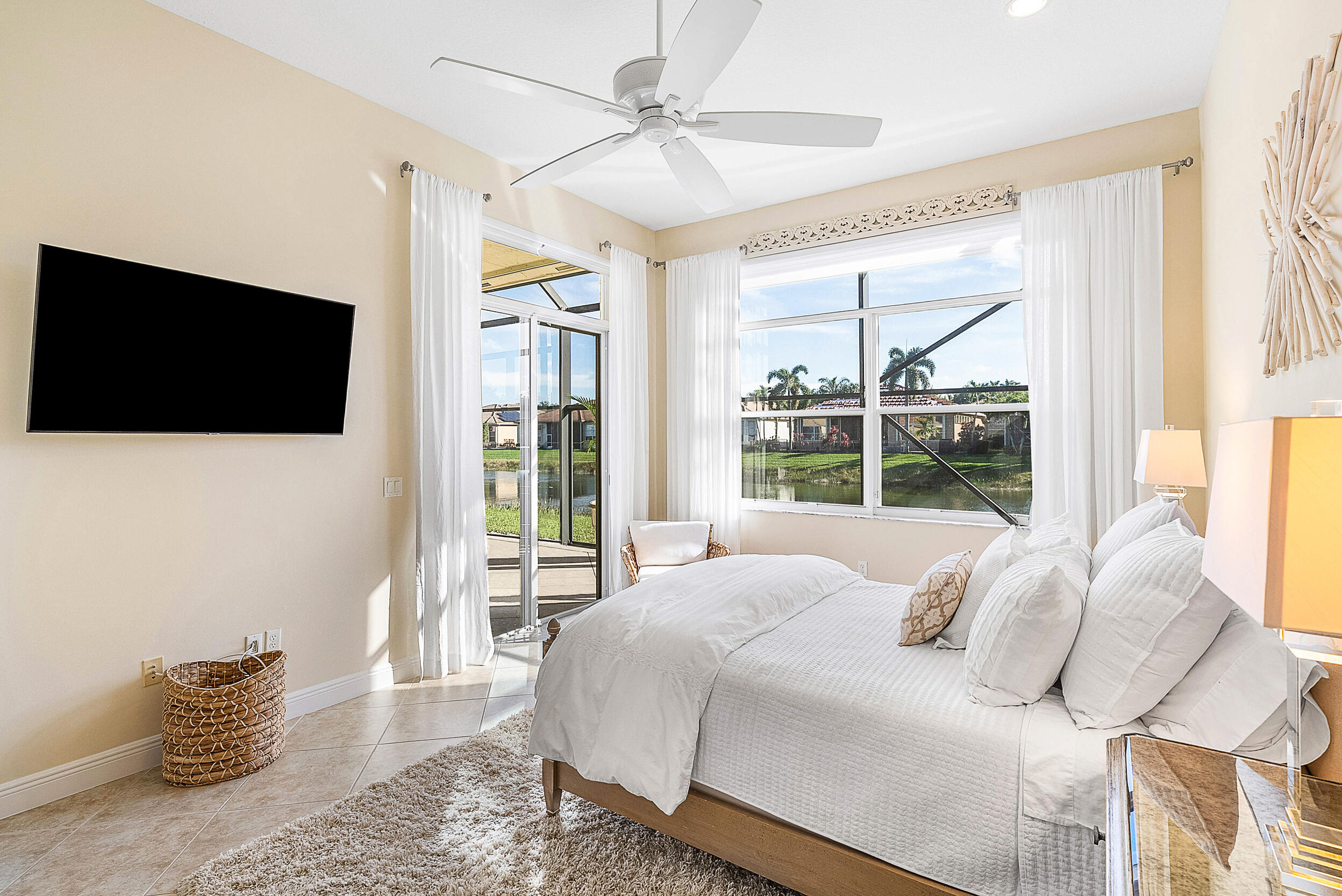 9666 Via Elegante Wellington, FL 33411 - Photo 17 of 37 a bedroom with a bed and a flat screen tv