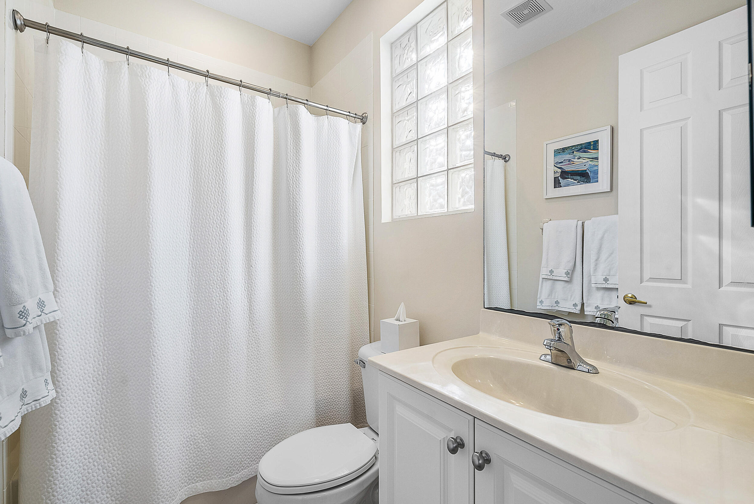 9666 Via Elegante Wellington, FL 33411 - Photo 21 of 37 a bathroom with a sink a toilet and shower curtain