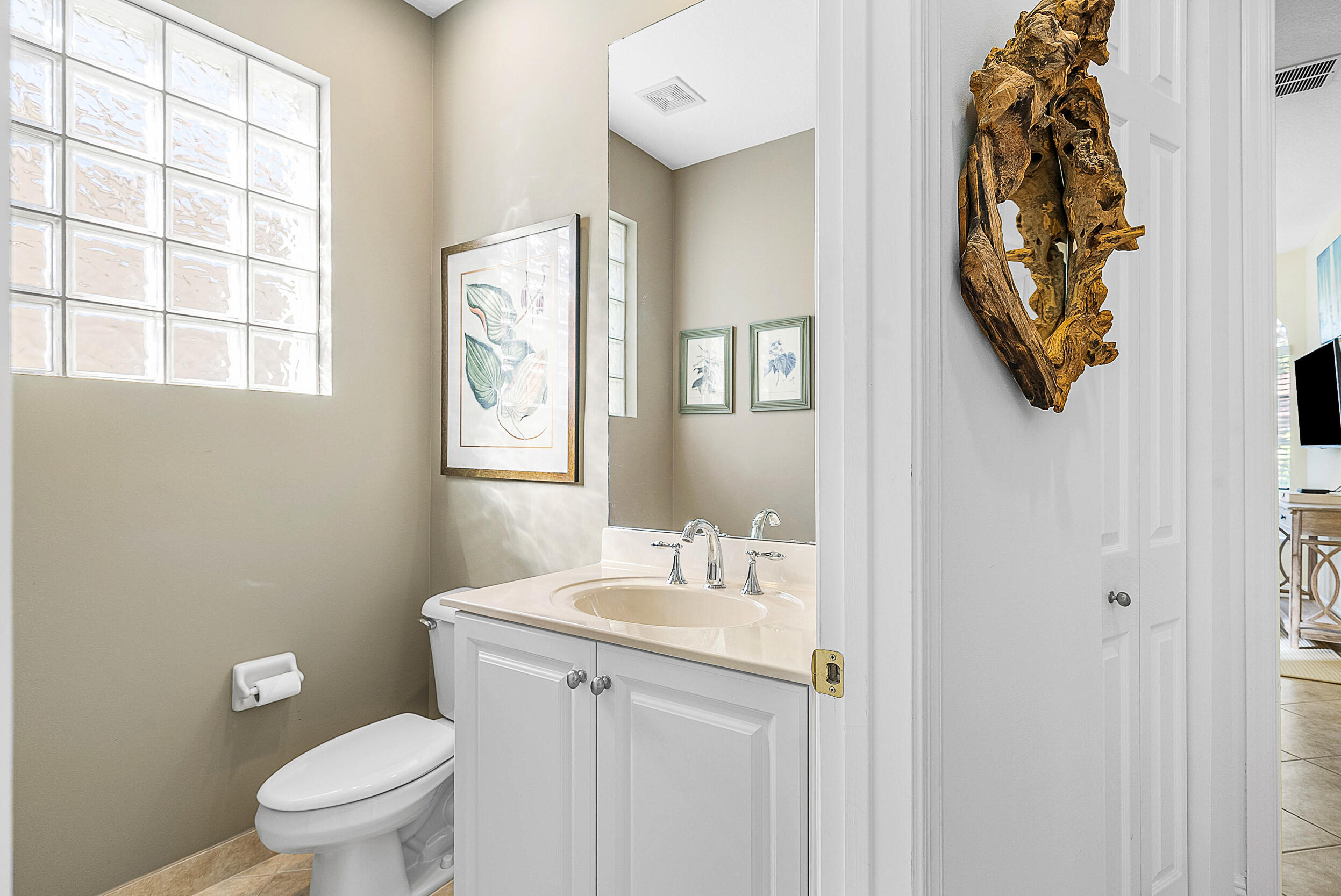 9666 Via Elegante Wellington, FL 33411 - Photo 22 of 37 a bathroom with a toilet a sink and a window