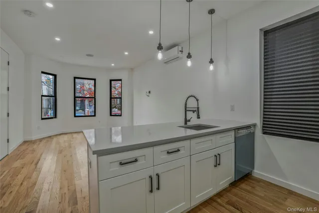 a spacious bathroom with a sink and a mirror
