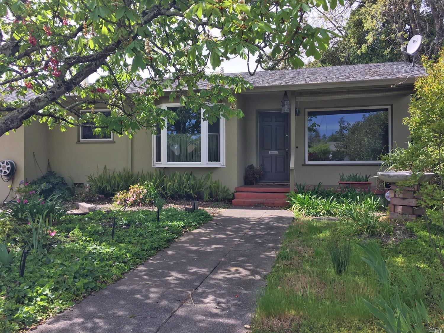 a front view of a house with garden