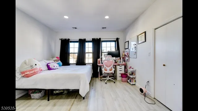 a view of livingroom with hardwood floor and flat screen tv