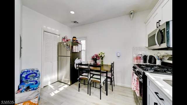 a view of a dining room with furniture and a kitchen