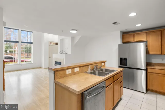 a view of kitchen with stainless steel appliances a refrigerator and microwave