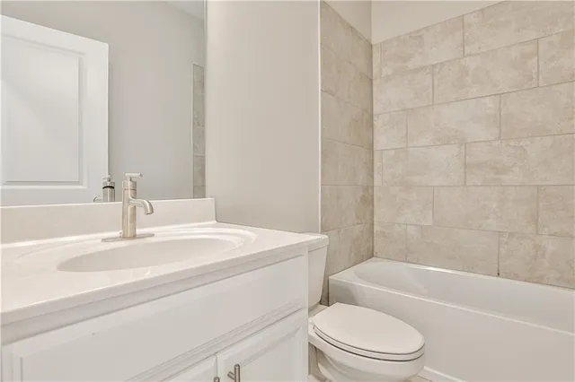 a bathroom with a toilet a sink and a bathtub