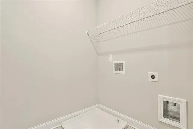 a small space with a white wall and a window