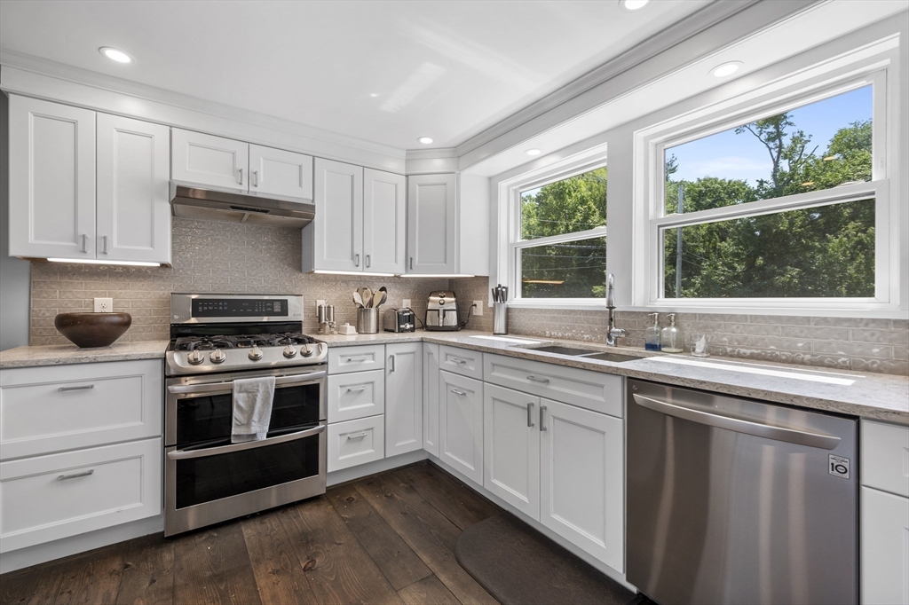 a kitchen with a sink stove and cabinets