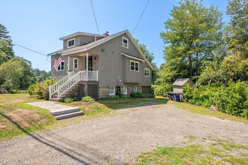 63 River Street Andover, MA 01810 - Photo 11 of 40 a front view of a house with a yard and garage