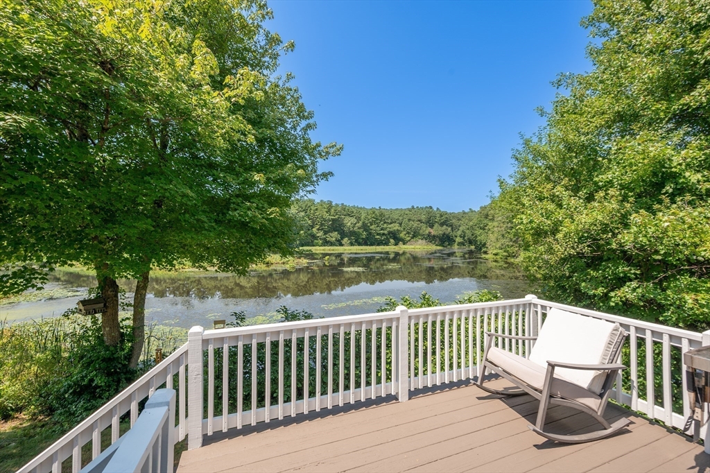 63 River Street Andover, MA 01810 - Photo 14 of 40 a view of a wooden deck and a yard with swimming pool