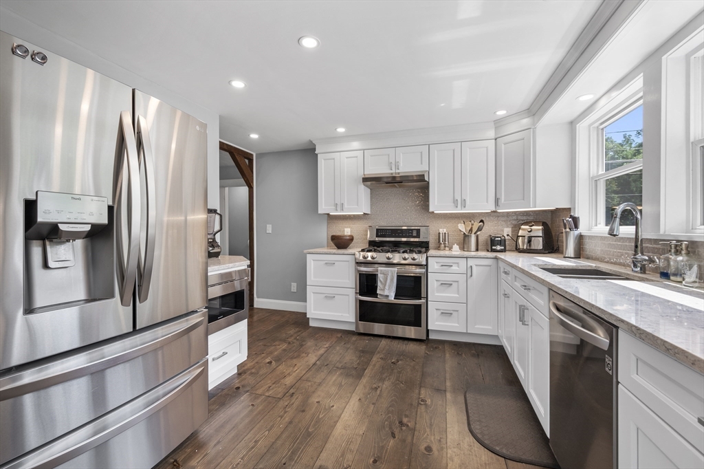 63 River Street Andover, MA 01810 - Photo 16 of 40 a kitchen with stainless steel appliances a refrigerator sink and stove